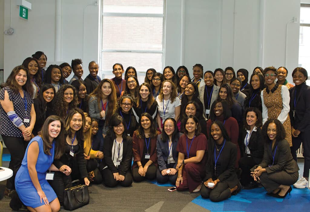 Image description: group of women in semi-circle posing for a picture