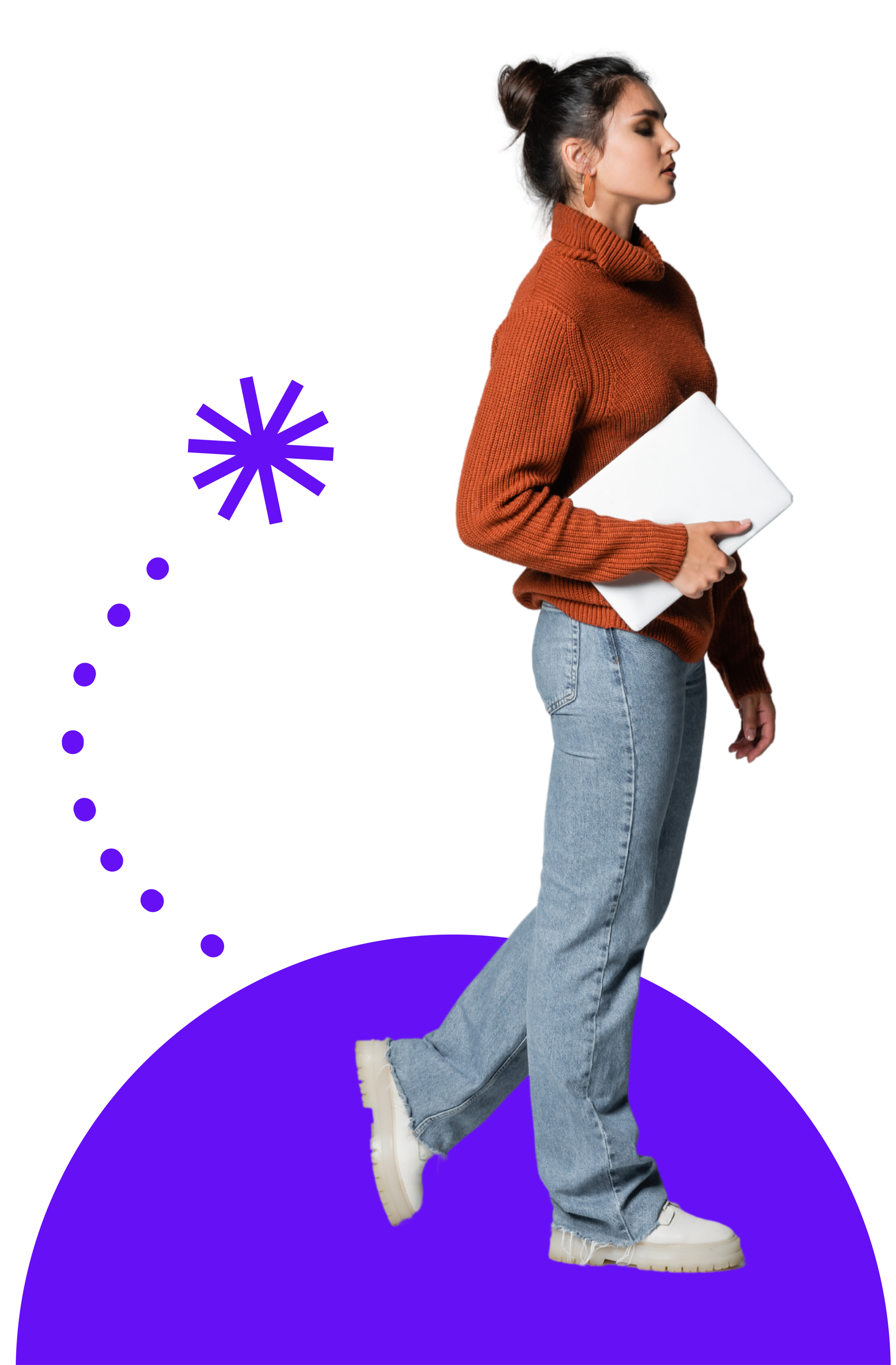 Woman standing wearing a maroon top, blue jeans and sneakers holding a laptop on the side with purple graphics in the back.
