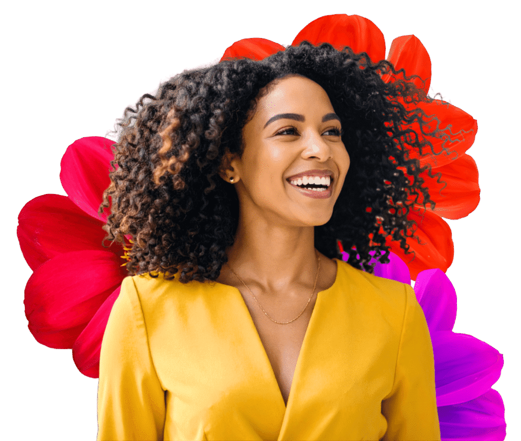 Woman wearing a yellow top with flowers behind her